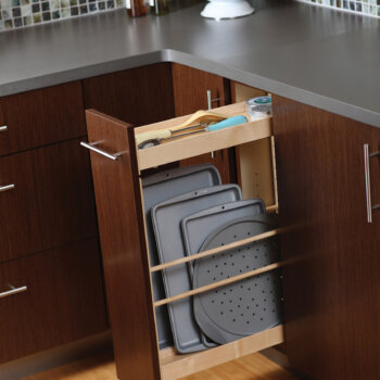 A thin, base pull-out cabinet with vertical tray storage for pans and cookie sheets from Dura Supreme Cabinetry.